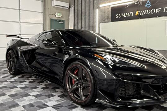 Black Corvette with paint protection film in a window tinting and PPF shop